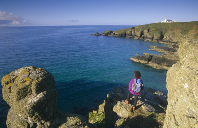 A person looking out on Lizard Point in Cornwall